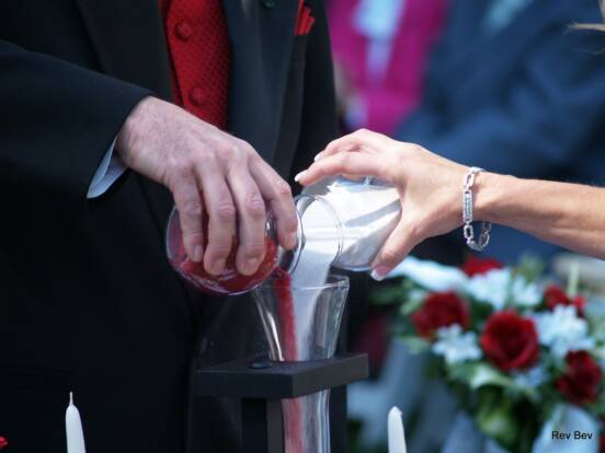 bride and groom pour sand together