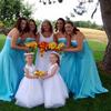 bridesmaids in teal blue dresses, flower girls in white dresses. Yellow and orange flowers