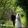 bride and groom walking up trail together. Path to ceremony.