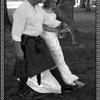 bride and groom step over the broom