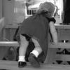 little girl in dress climbing stairs